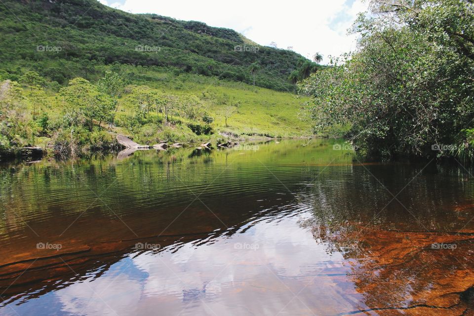 River with reddish tone amidst nature preserved in Brazil