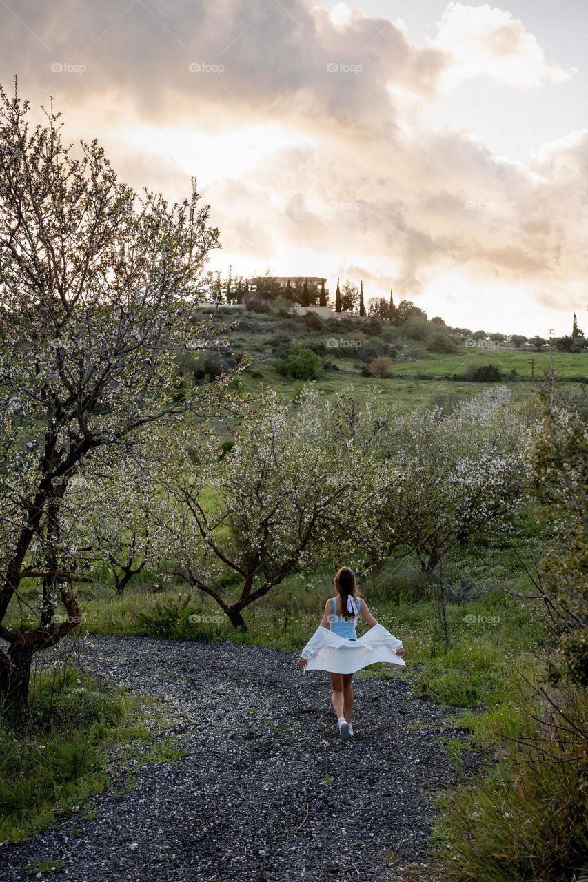 Young woman walking on picturesque road