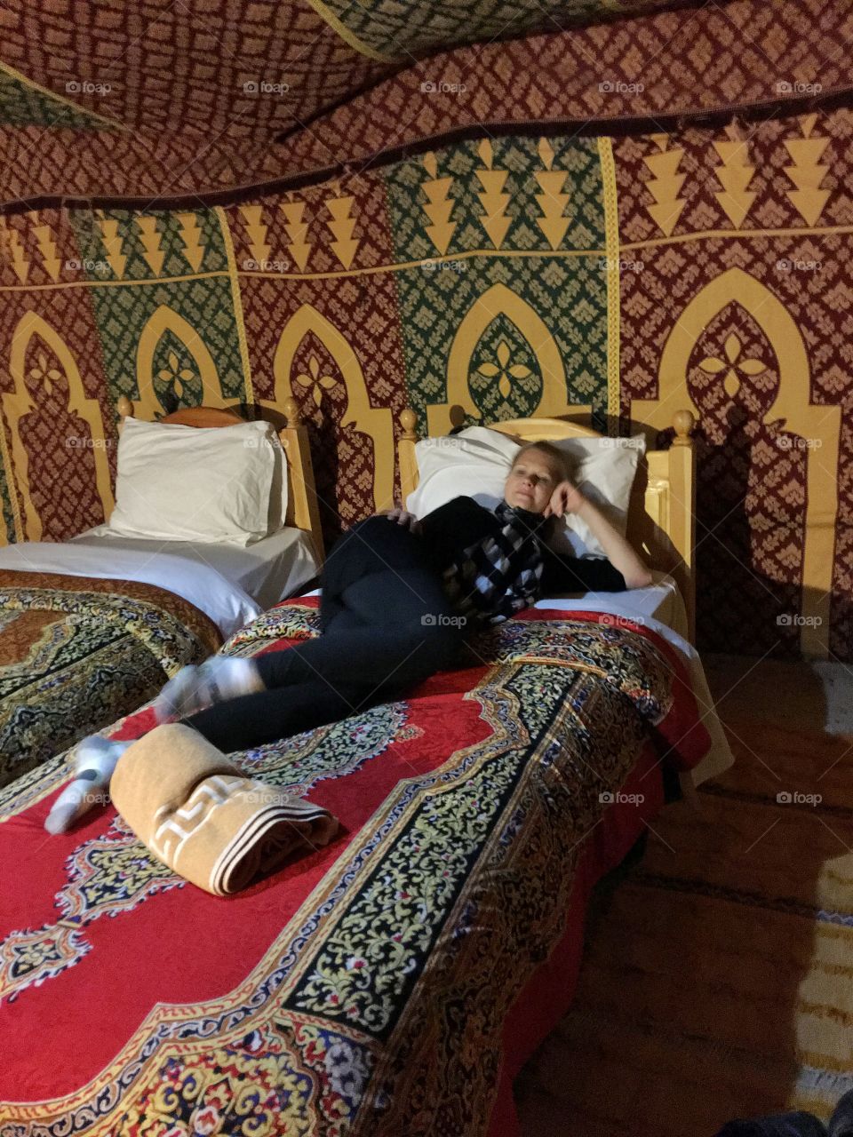 Woman resting on bed