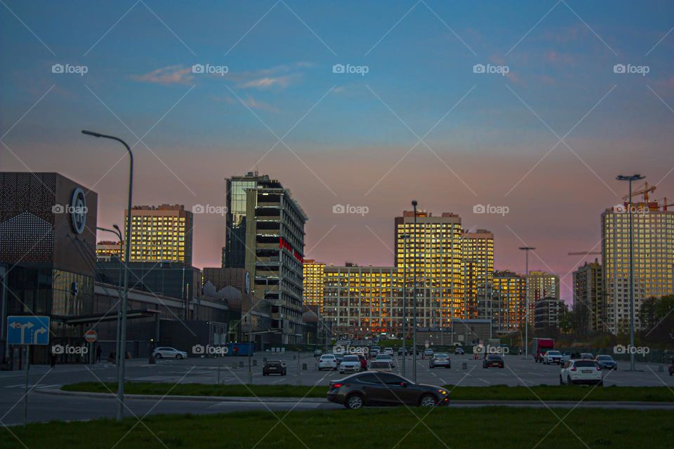 reflection of the sunset on the windows of high-rise buildings 