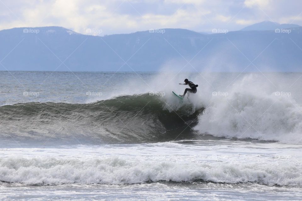 Surfer riding on top of the wave