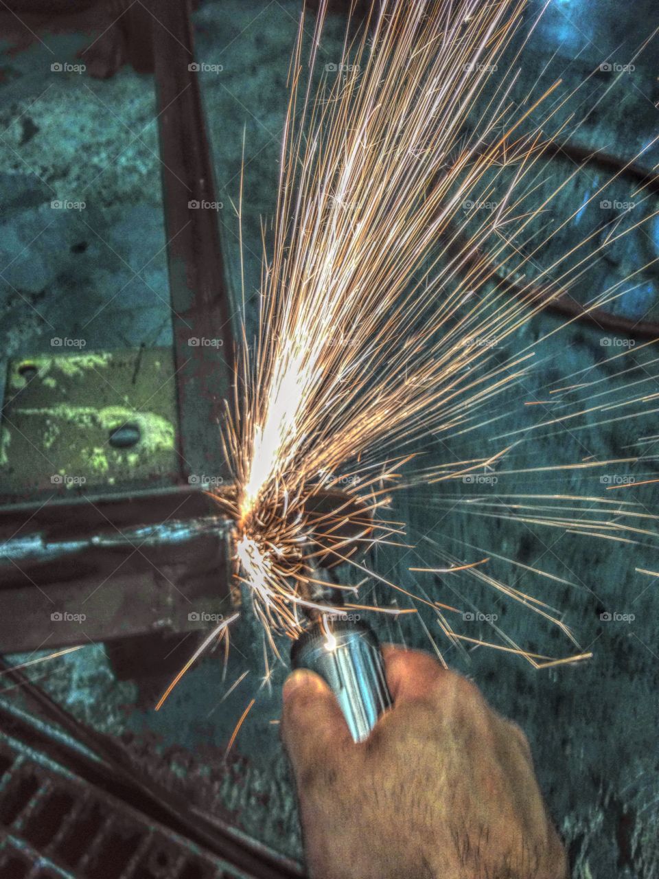 Person grinding using work tool