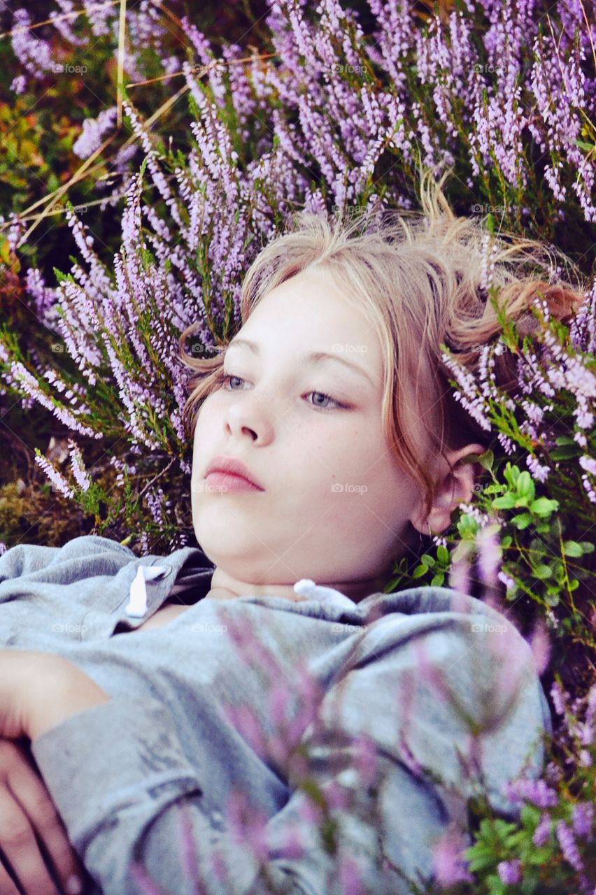 Young woman lying on meadow