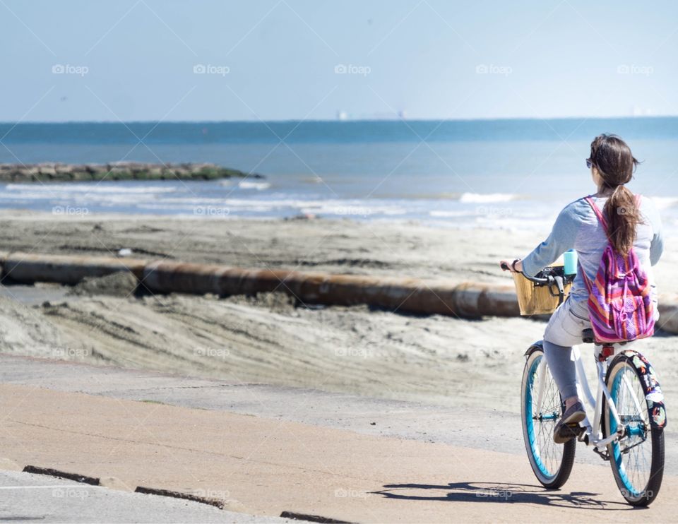 Female biking along beach