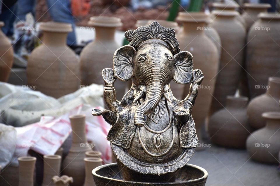 This is a beautiful metallic idol of Hindu God Ganesh which is focused. This picture was taken from Kolkata handicraft fair on Eco Park.