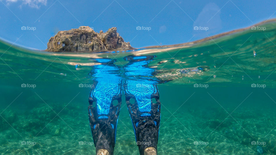 Over under photo of snorkel fins while on summer vacation