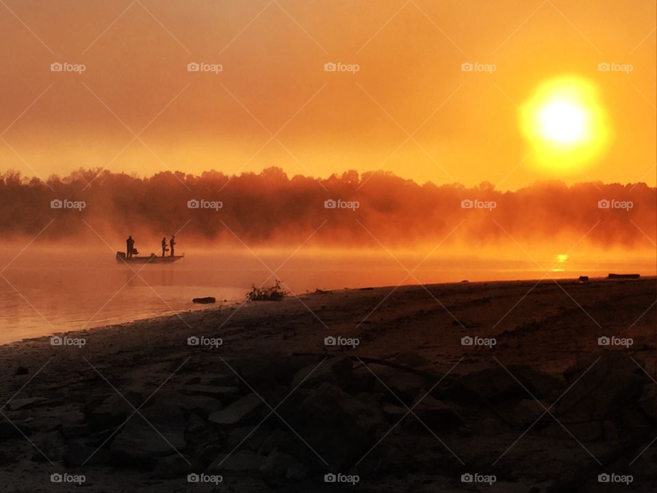 Group of a people fishing during sunrise