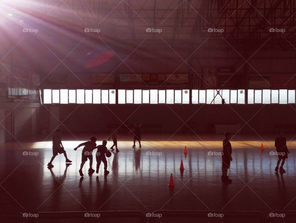 school kids playing basketball inside hall