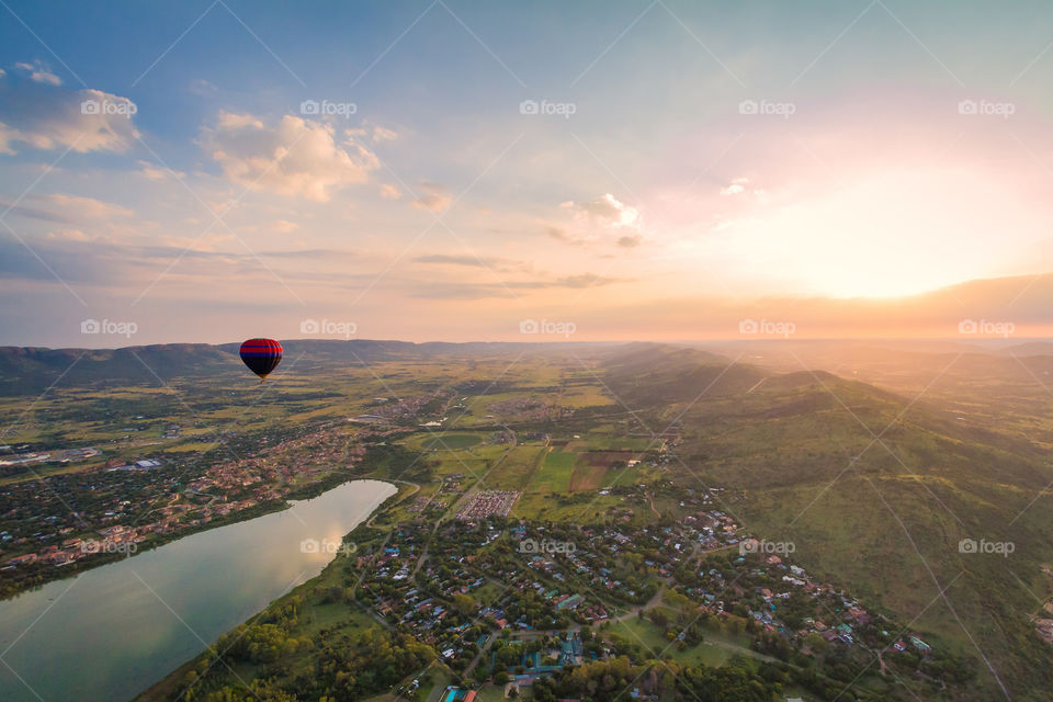 Hot air balloon sunrise in Africa with beautiful view over Hartbeespoort dam and town. Calm and serene sunrise.