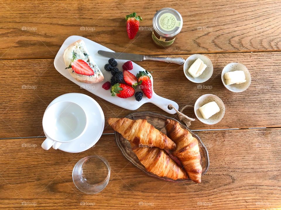Breakfast with croissants, butter, cheese, strawberry 