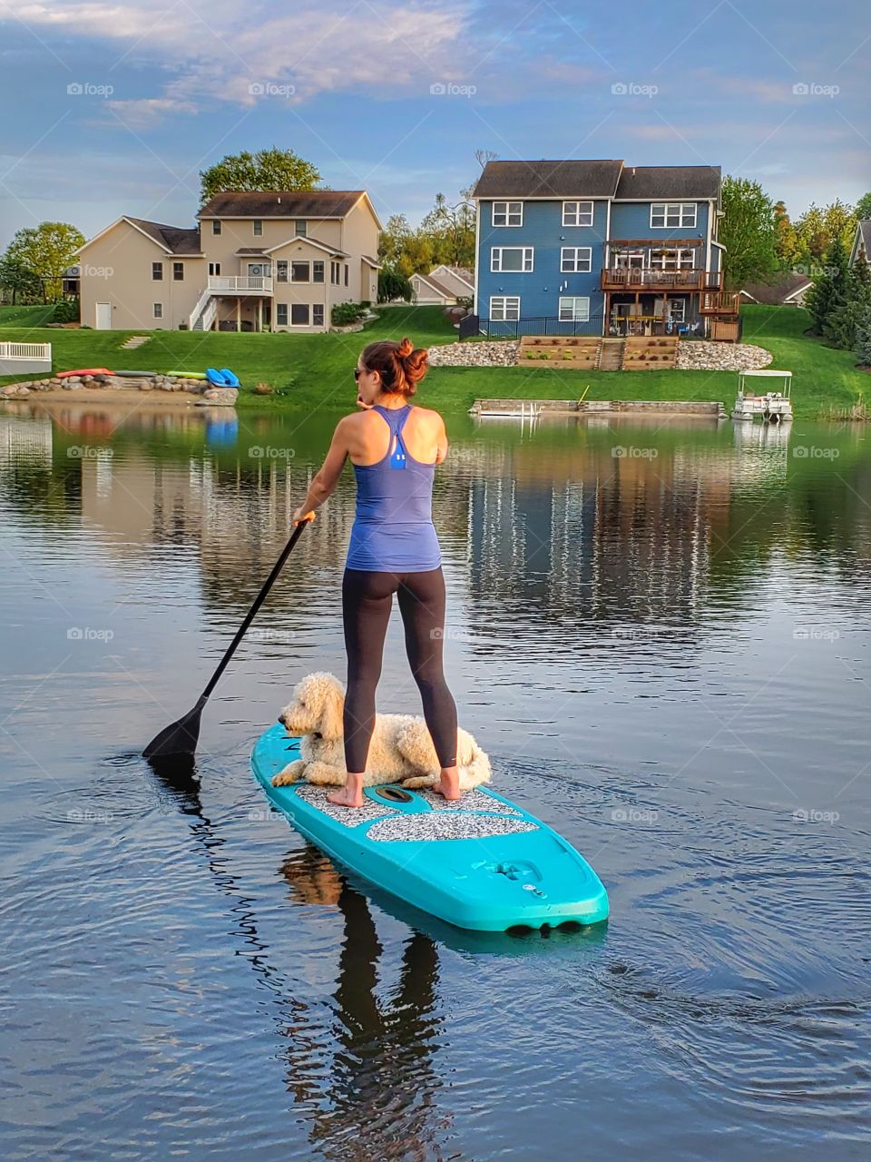 paddleboard in neighborhood lake with dog