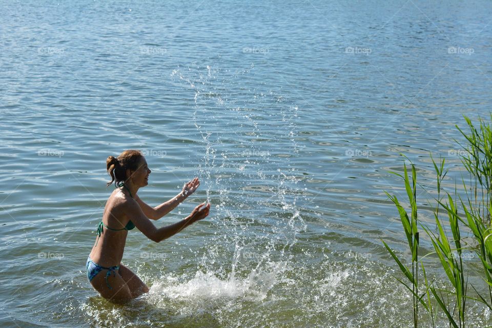 happy woman in water lake summer heat