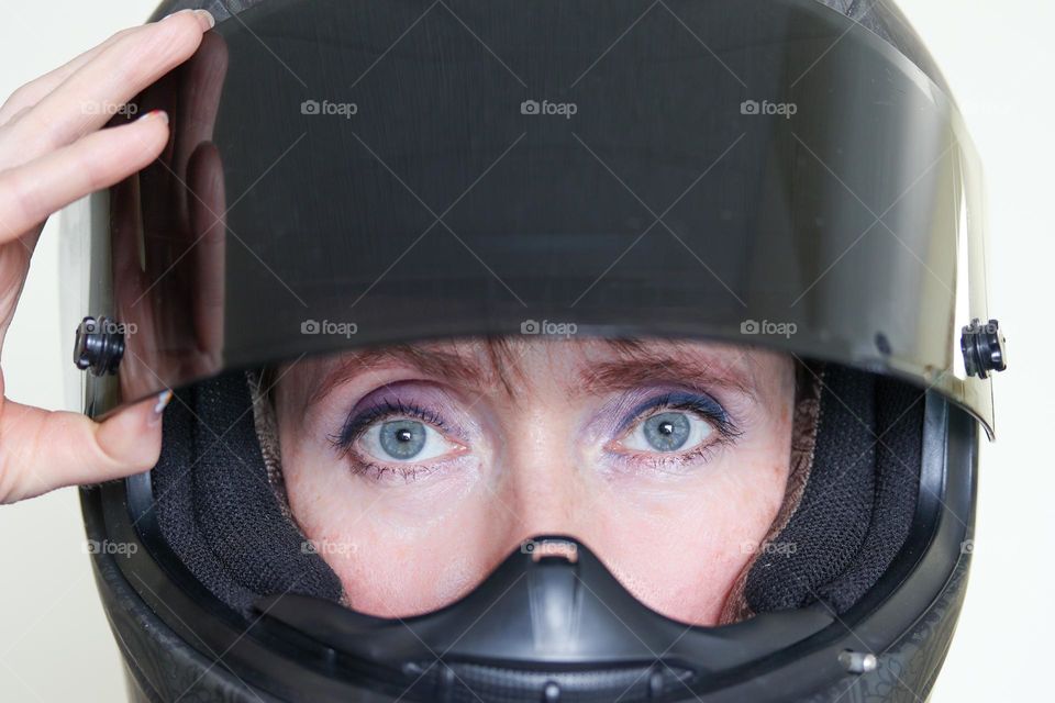 Purple eye shades and motorcycle helmet on a woman