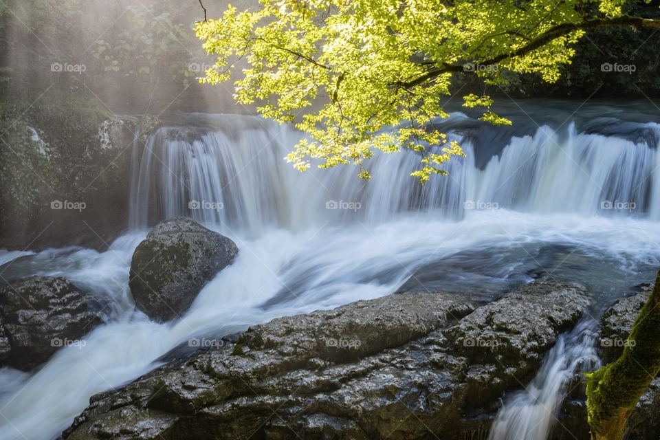 Beautiful scene of waterfall and beam of sun light