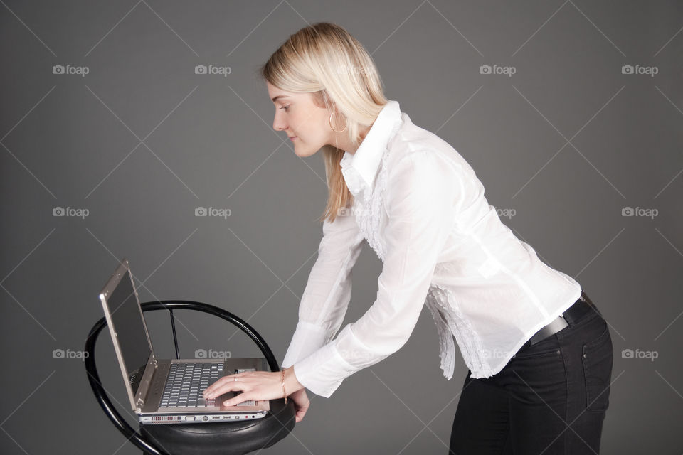 Girl with notebook on gray background