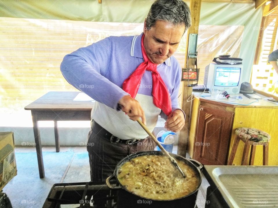 Man cooking typical food