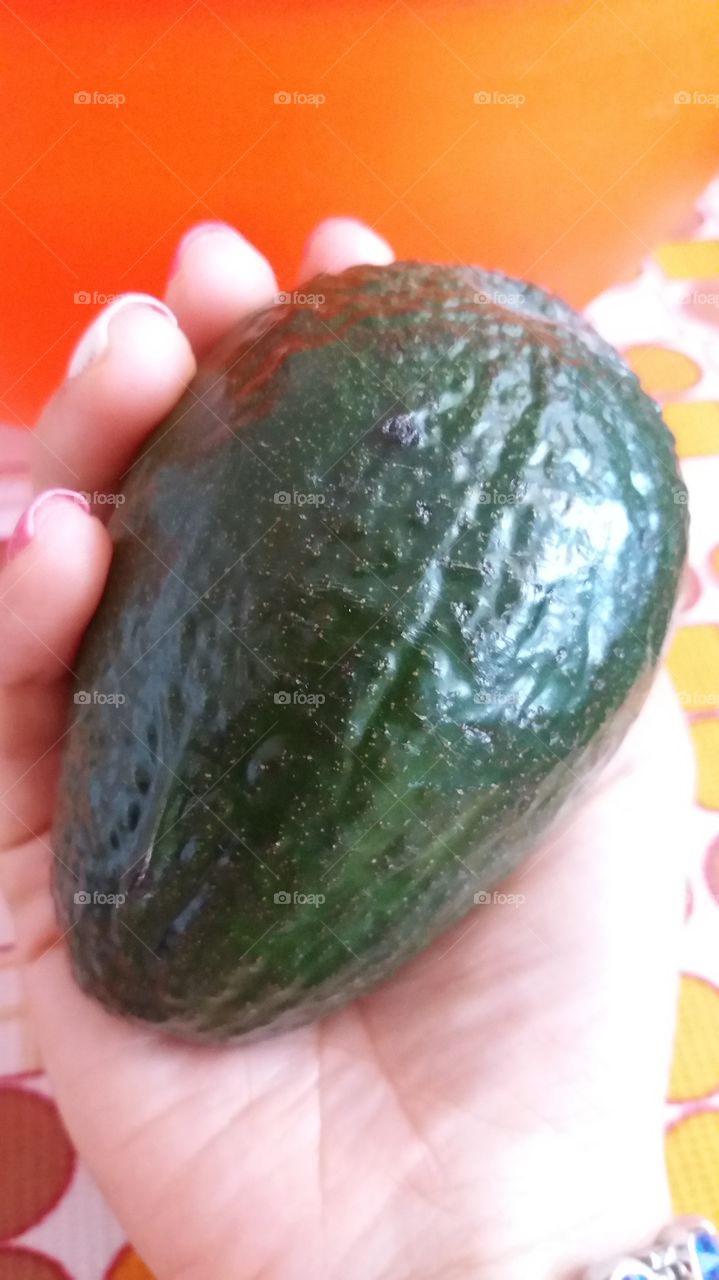 Holding an avocado