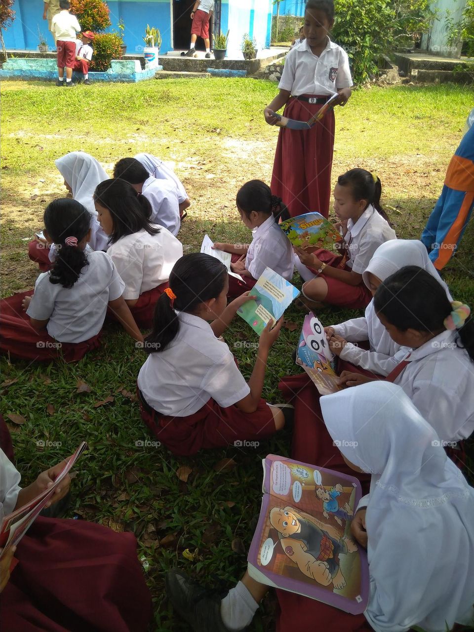 Seeing the Happiness of Dayak School Children While Reading Books in the School Yard Amuntai Regency, South Kalimantan, Indonesia
