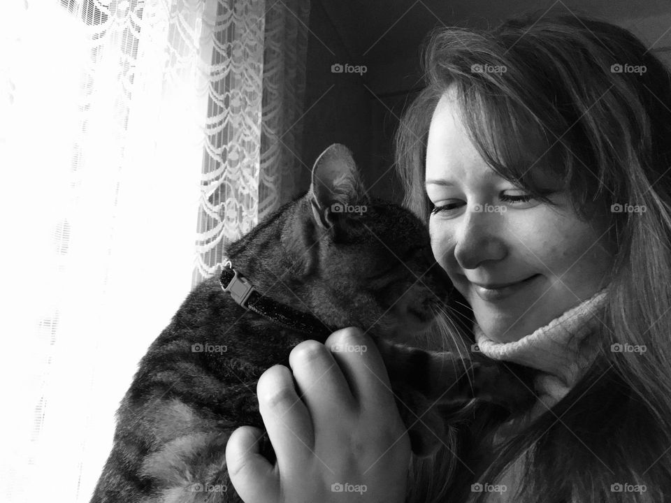 Black and white photography of a girl and her cat.