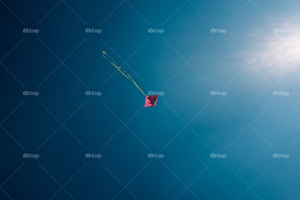 Minimalist Pink Kite Dots Through Blue Sky