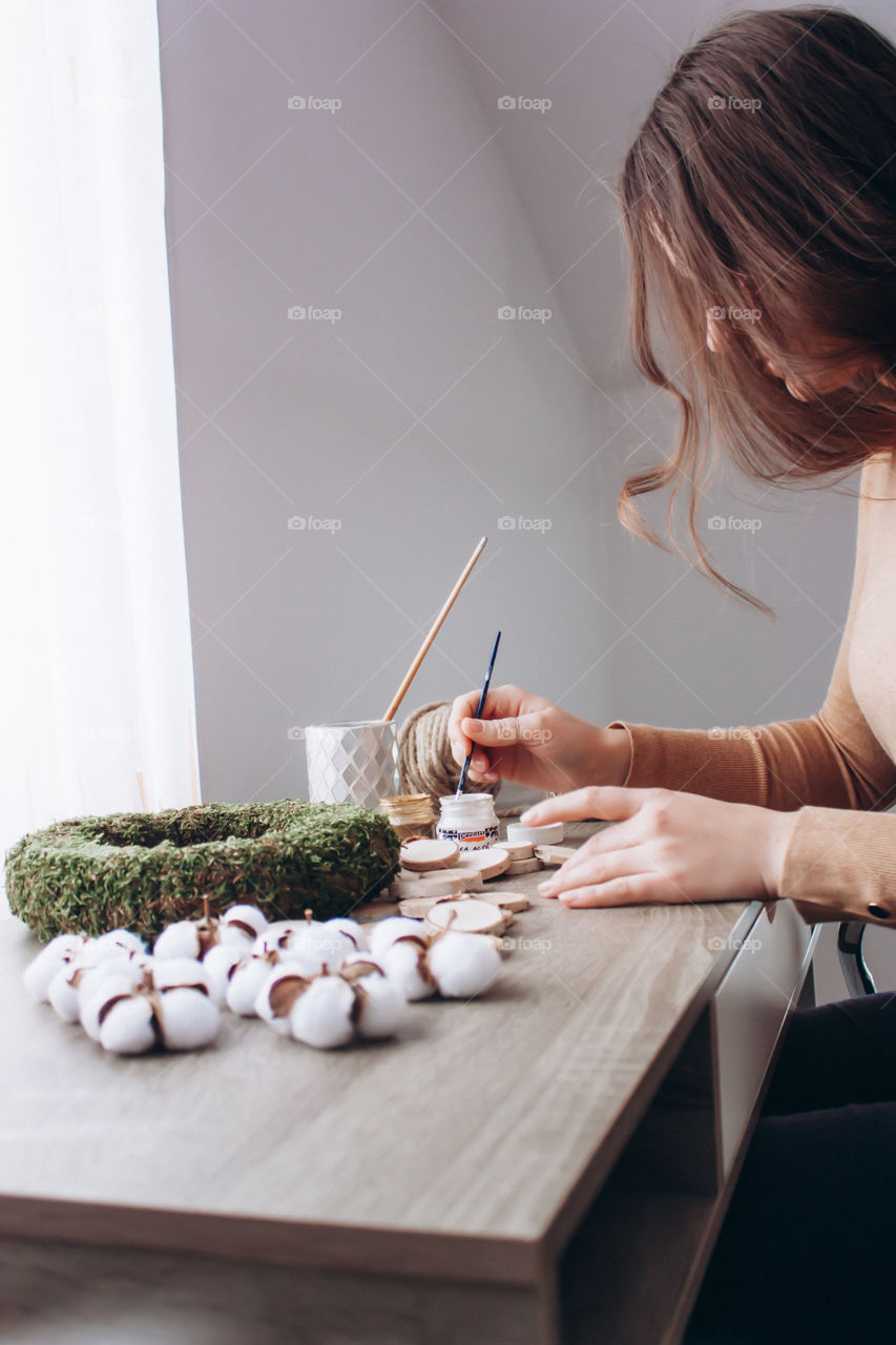 photo of a woman crafting an Easter wreath made only from eco friendly materials