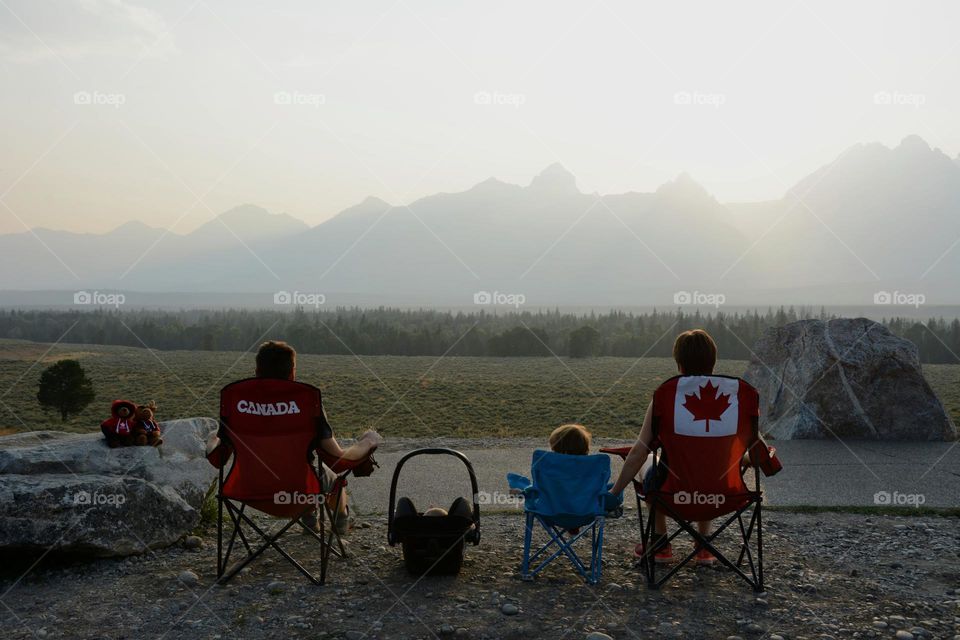 Young family enjoying the sunset over the wide plains of Canada