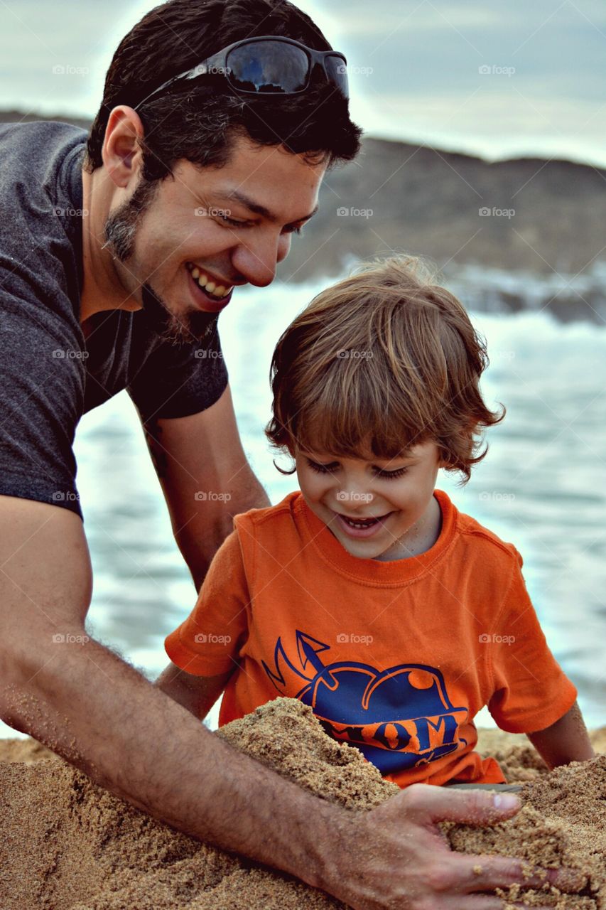 The Beach. My husband and son having fun in the sand.