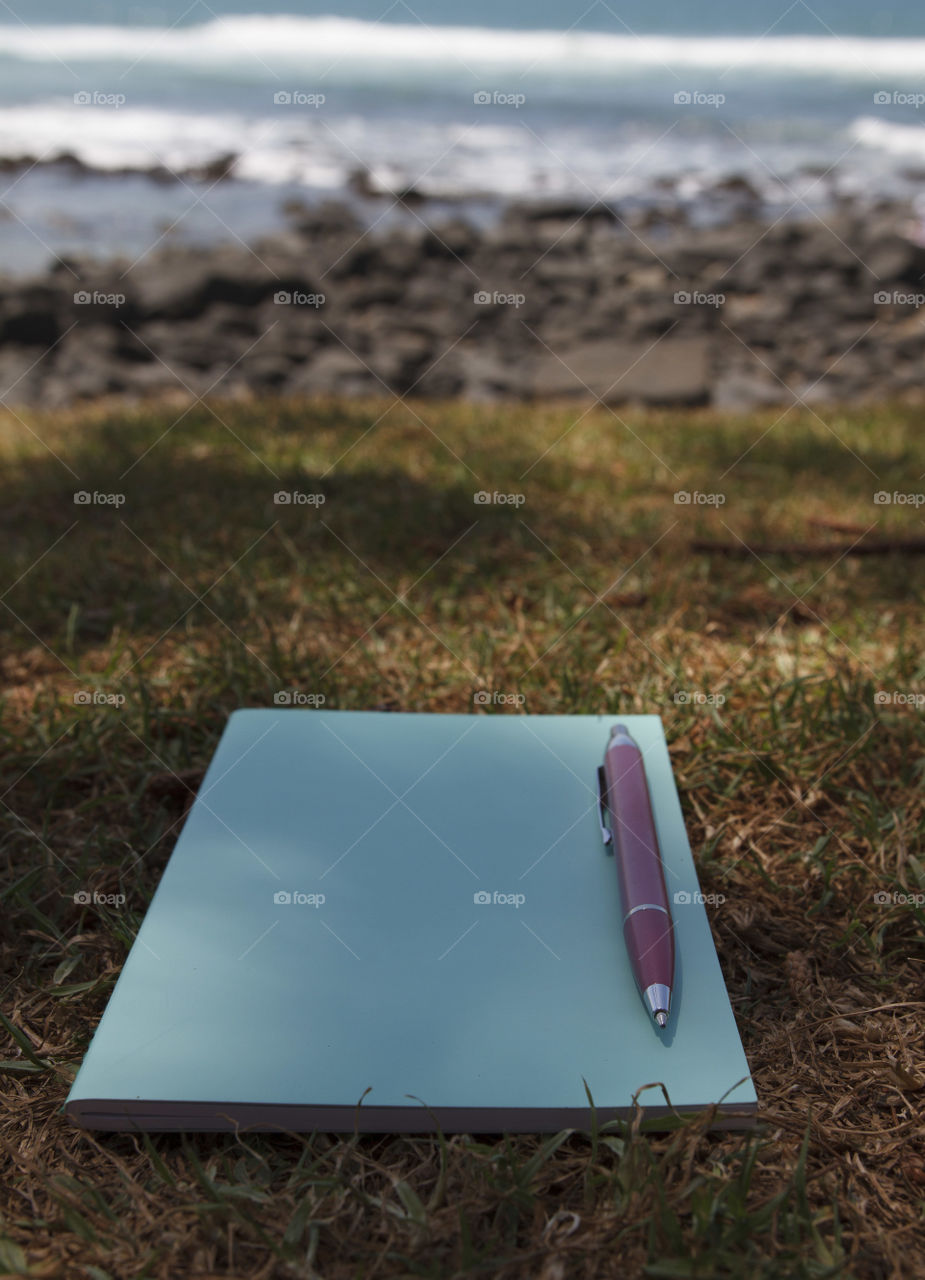 Notepad & pen by the sea