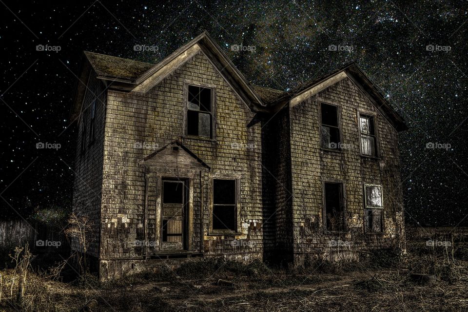 Exterior of old abandoned house at night