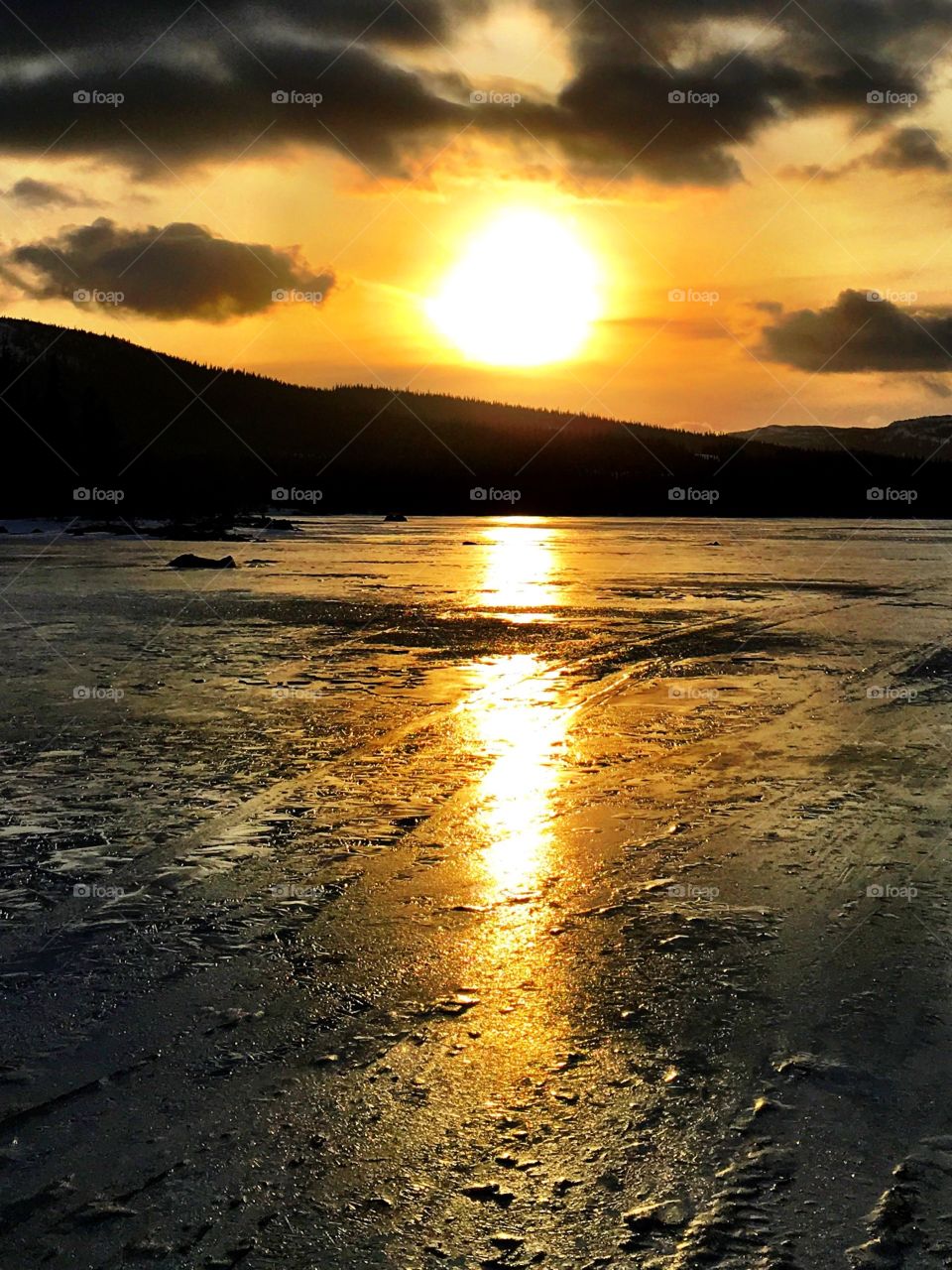 Sunset on icy lake 
