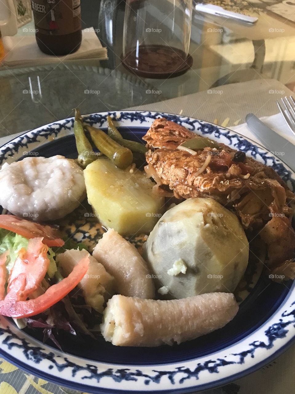 Stewed Red Snapper, yellow and white yam, green banana, dumplings salad and okras