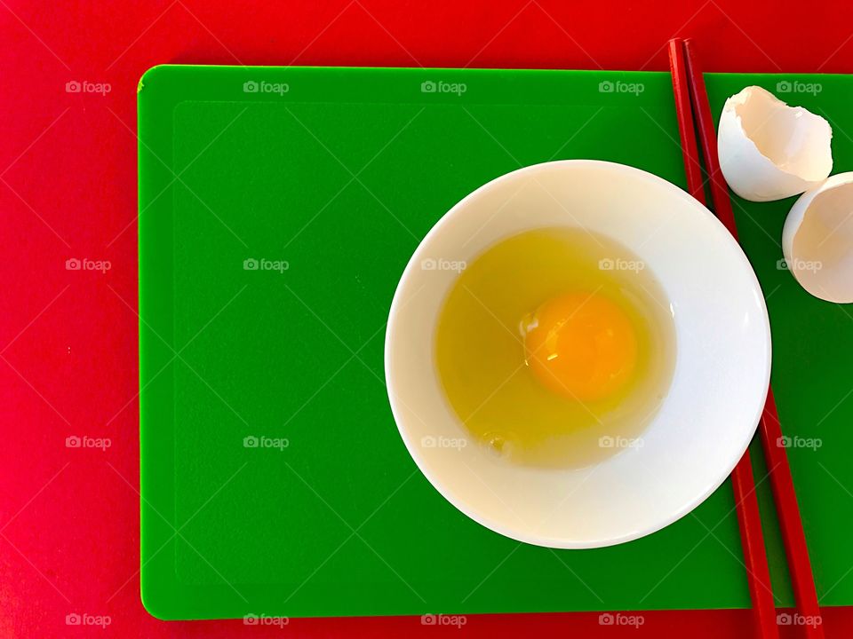 Egg with chopsticks on cutting boards