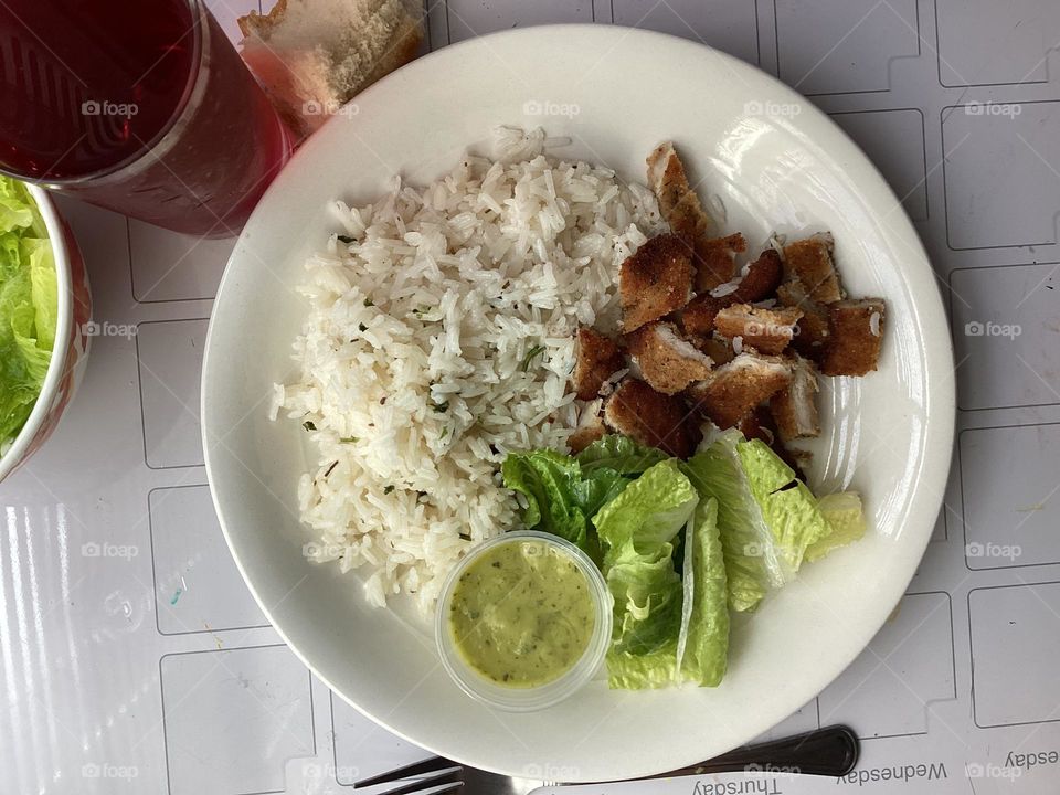 White rice with parsley ,lettuce salad and chicken fried 