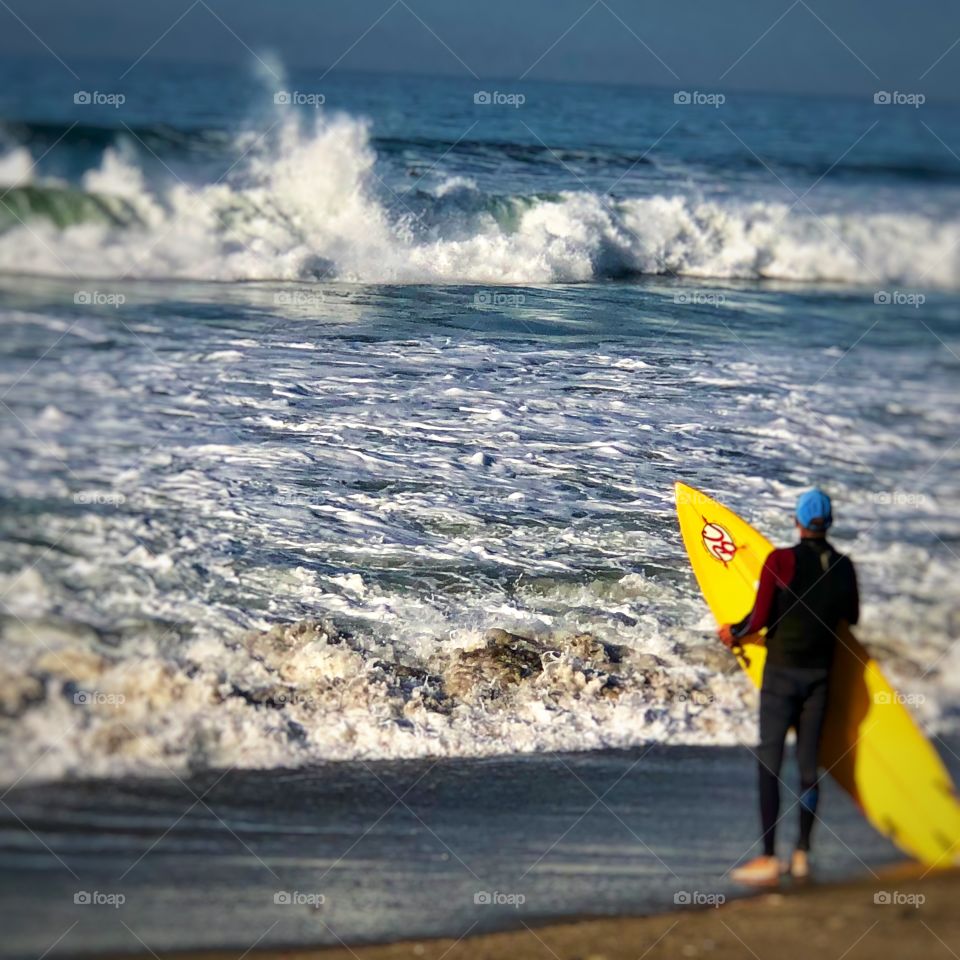 Surfer Contemplating Surfing the Spectacular Waves