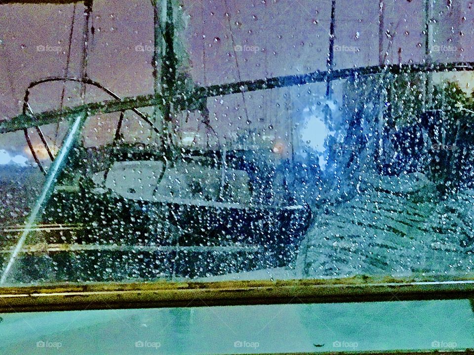 The boats in Long Island City’s Newtown Creek in the rain as the night begins as seen through the window pane of our own vessel, the “Salvation”. This photo is from the Spring of 2019. Hypnotic Productions