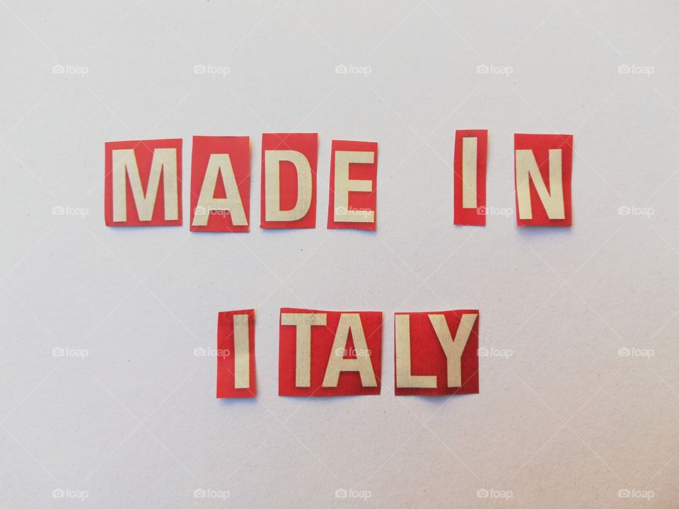 Inscription: "made in italy" with newspaper clippings