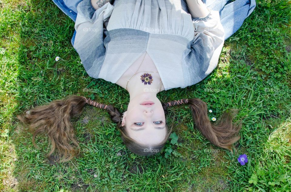 Portrait of Young Girl on Background of Daisies