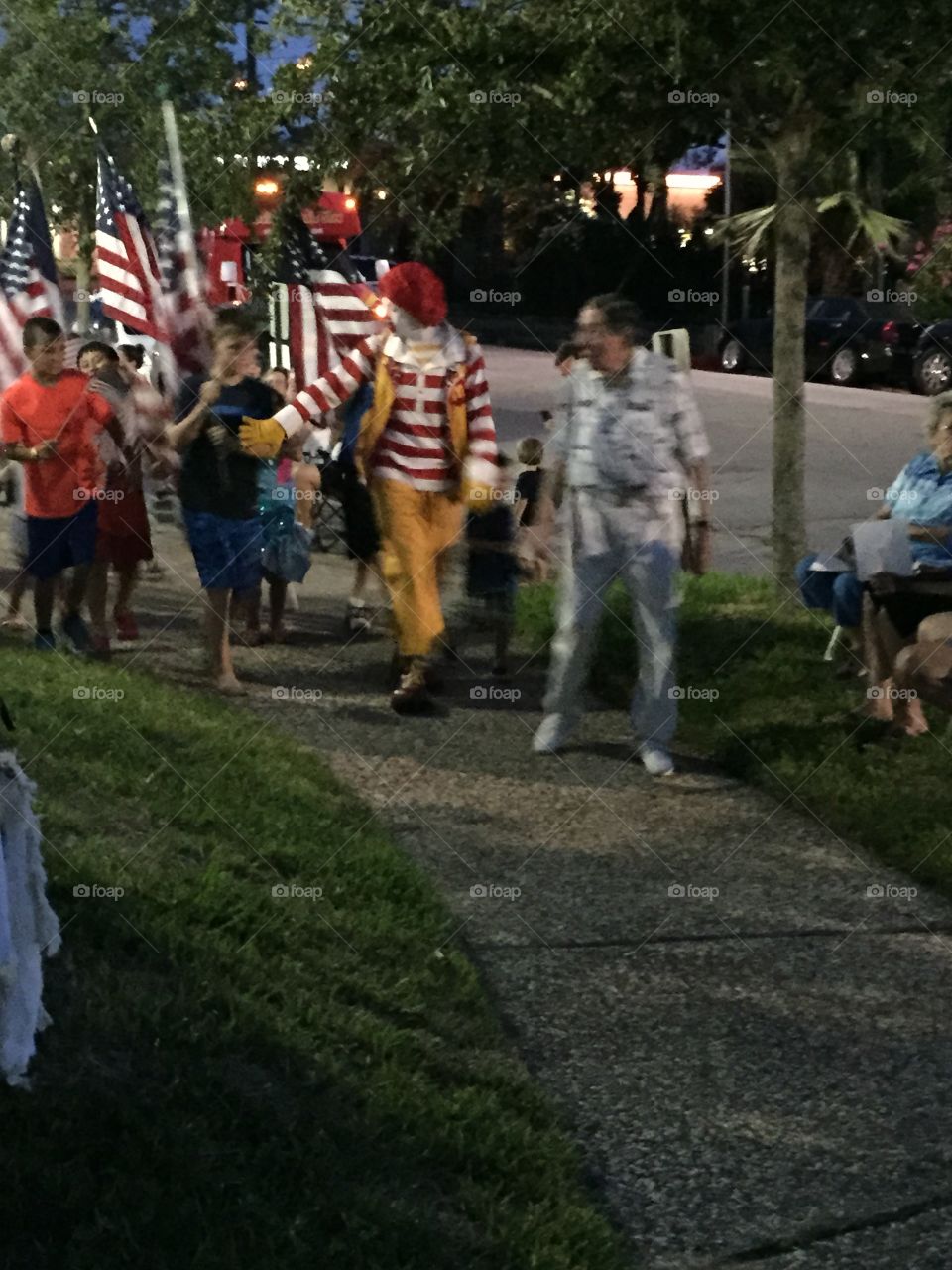 Ronald McDonald leading the flag parade 