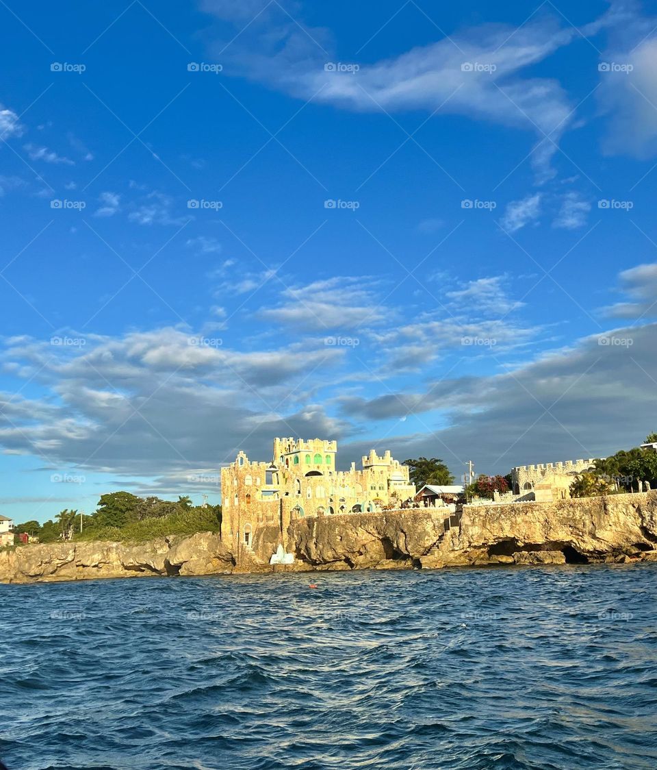 The Blue Cave Castle in Jamaica emerges sitting atop a beautiful cave, a storybook illustration come to life. Enveloped in sapphire waters, the castle's rustic charm is a stark contrast to the tropical paradise.