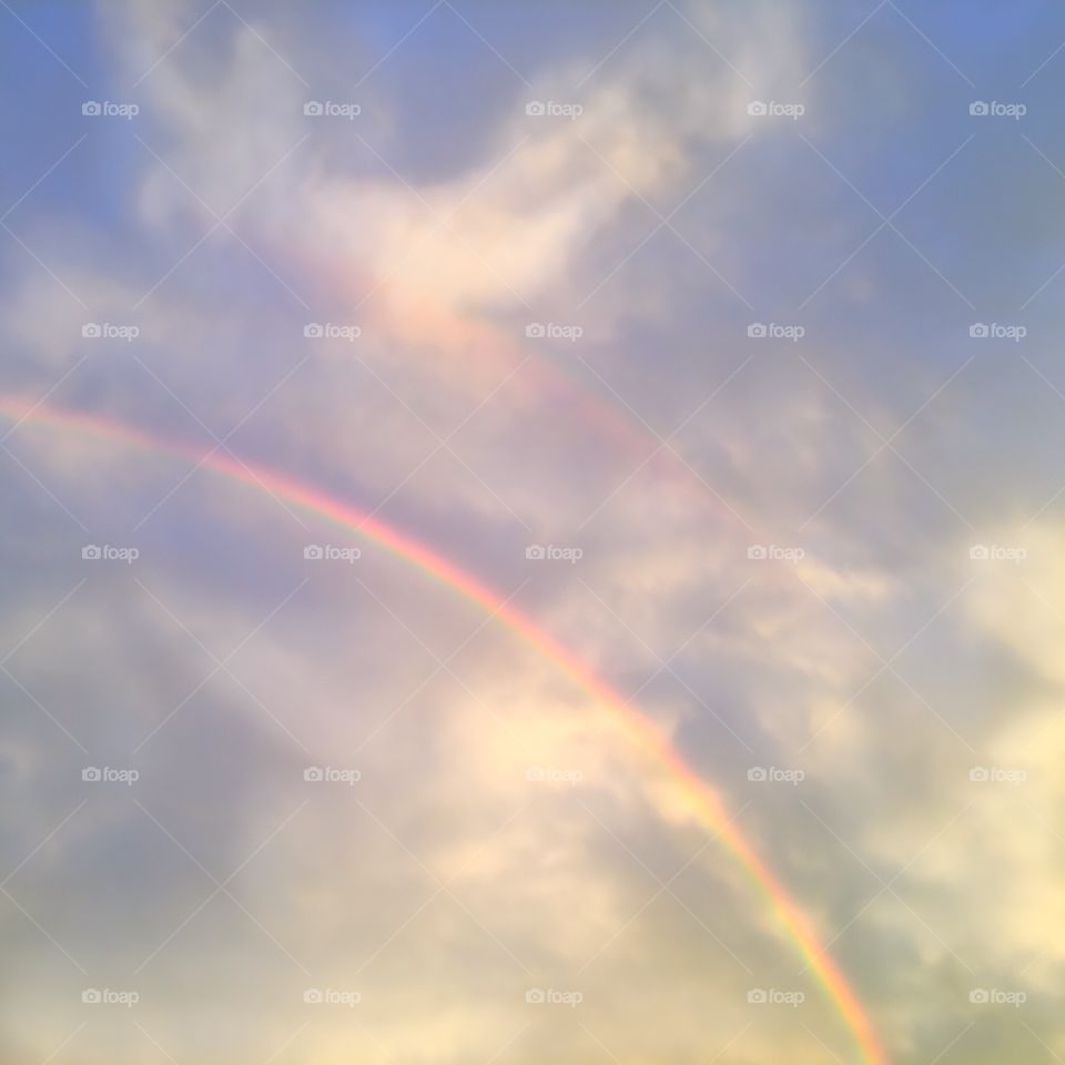 Beautiful double rainbow through the clouds.