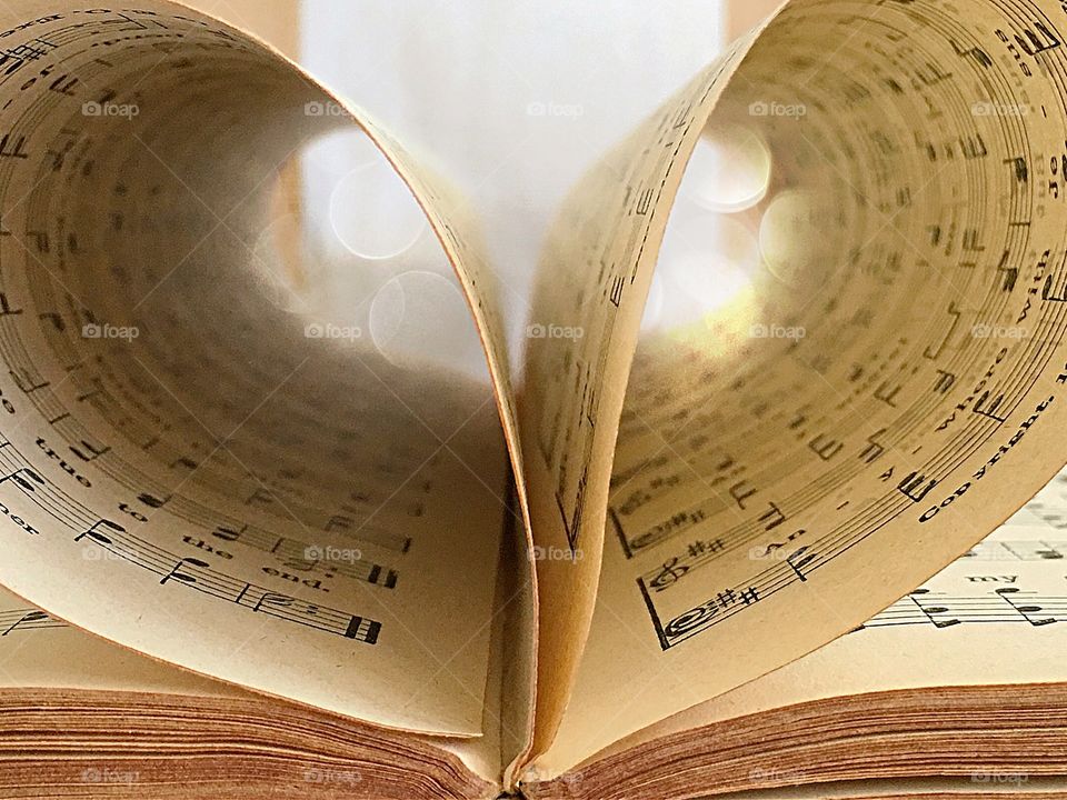 Old antique Christian hymnal book with heart shaped pages