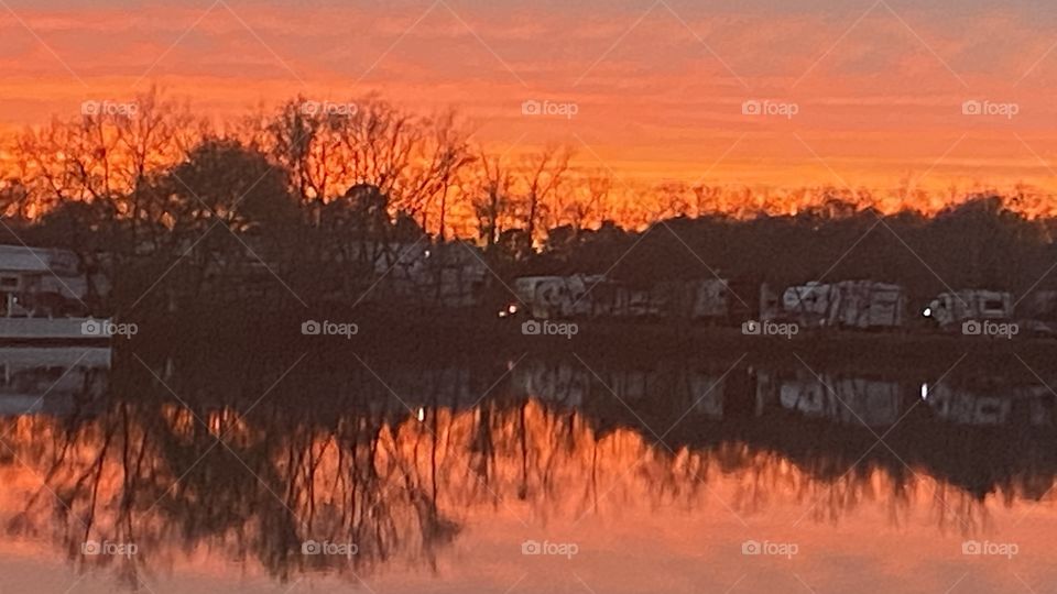 Red Sky At Night Sailors Delight. Sunlit Twilight Reds, Yellows, Oranges Streaking Across The Lower Sky. Total Reflections Covering the Landscape and on Lake Waters 