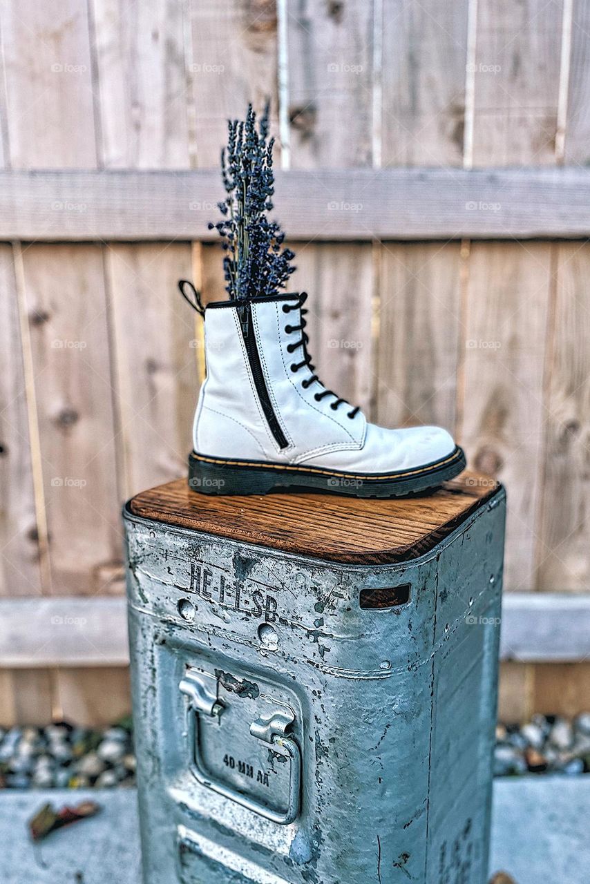 Doc Marten white boots with lavender stalks, Dr. marten boot as a vase, flowers and Docs, old school Dr. marten boots, DMs used creatively, boots as a vase, flowers and punk style, prom with Docs, ammo cans and Dr. Marten boot