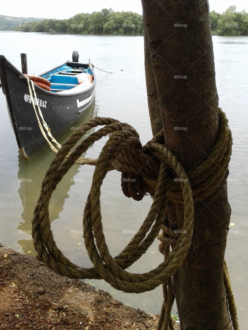 Autumn reflection boat tired in river