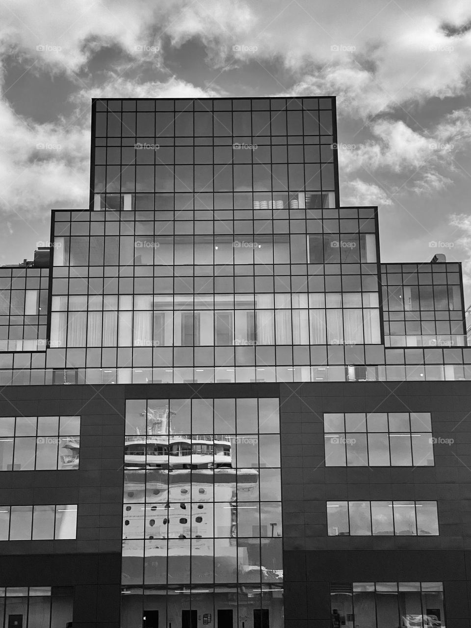 Reflection of a cruise ship in the windows of a building
