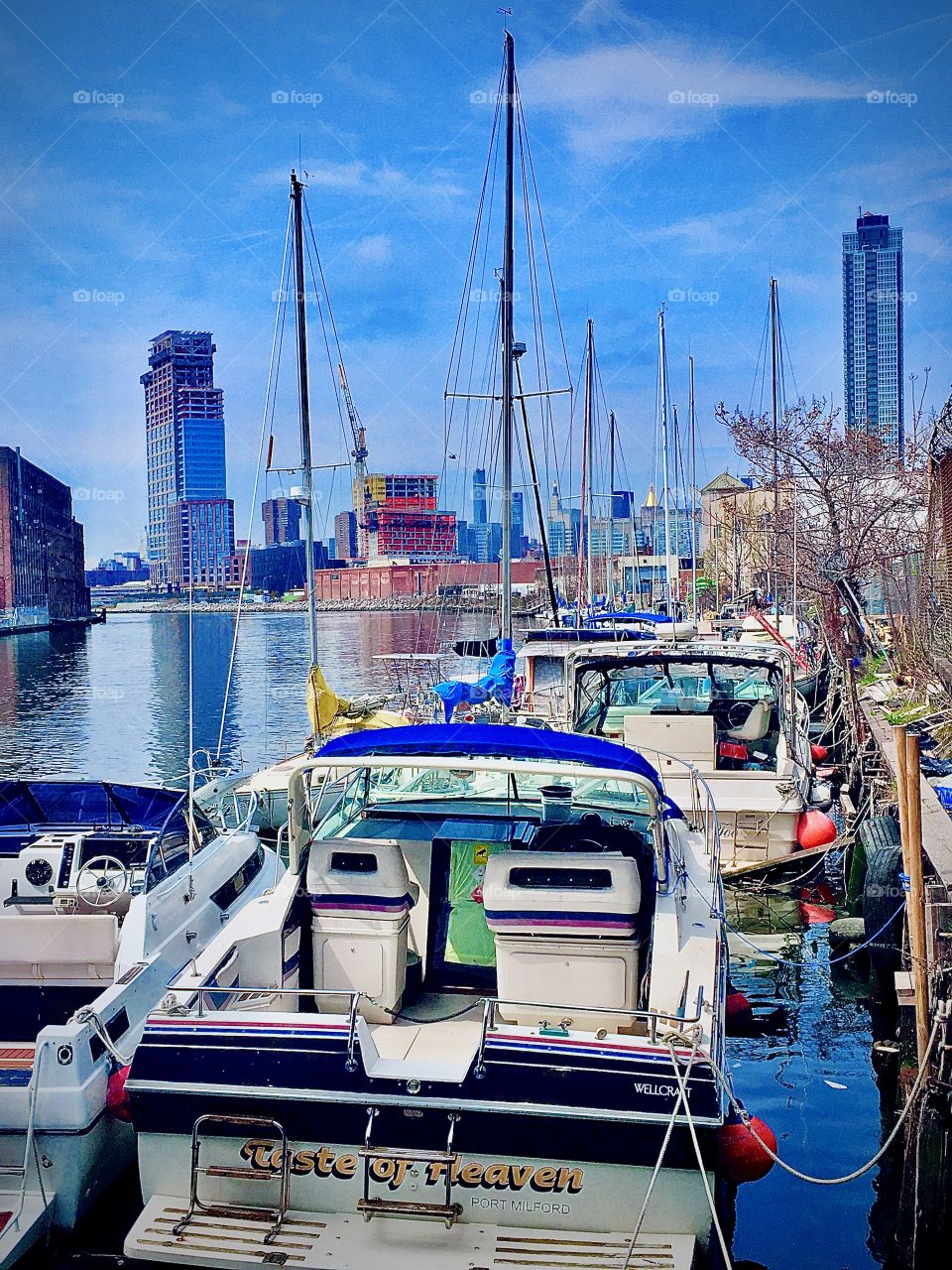Newtown Creek in Long Island City, Queens, New York with sailboats and other boats in the early afternoon. This picture was taken in the summer of 2020. Hypnotic Productions