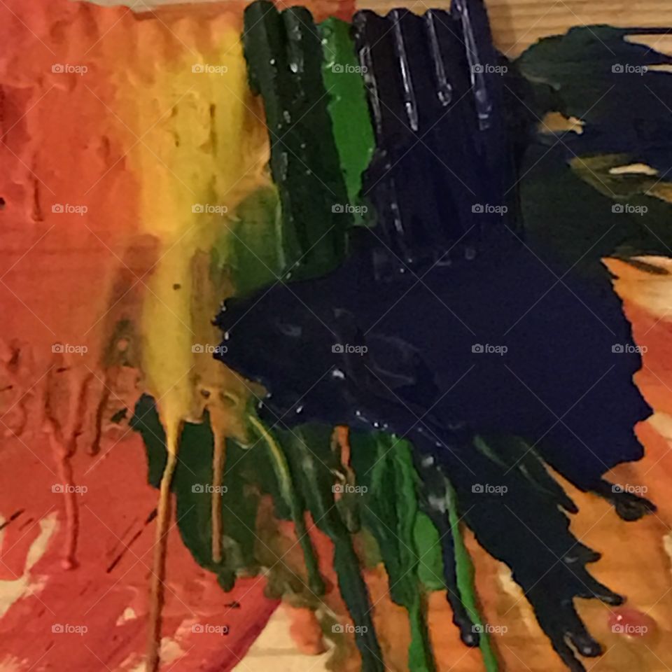 Using hot air to melt crayons causes colors to splatter creating an abstract painting