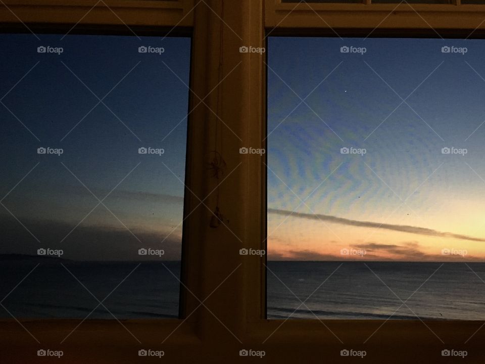 Sunset through screened window frame