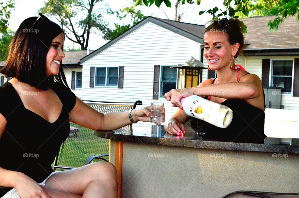Woman pouring white rum in glass