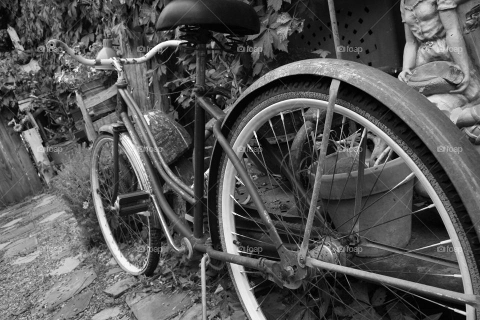 Black and white photo of old vintage bike in a junk ally, location is Jasper, Arkansas.
